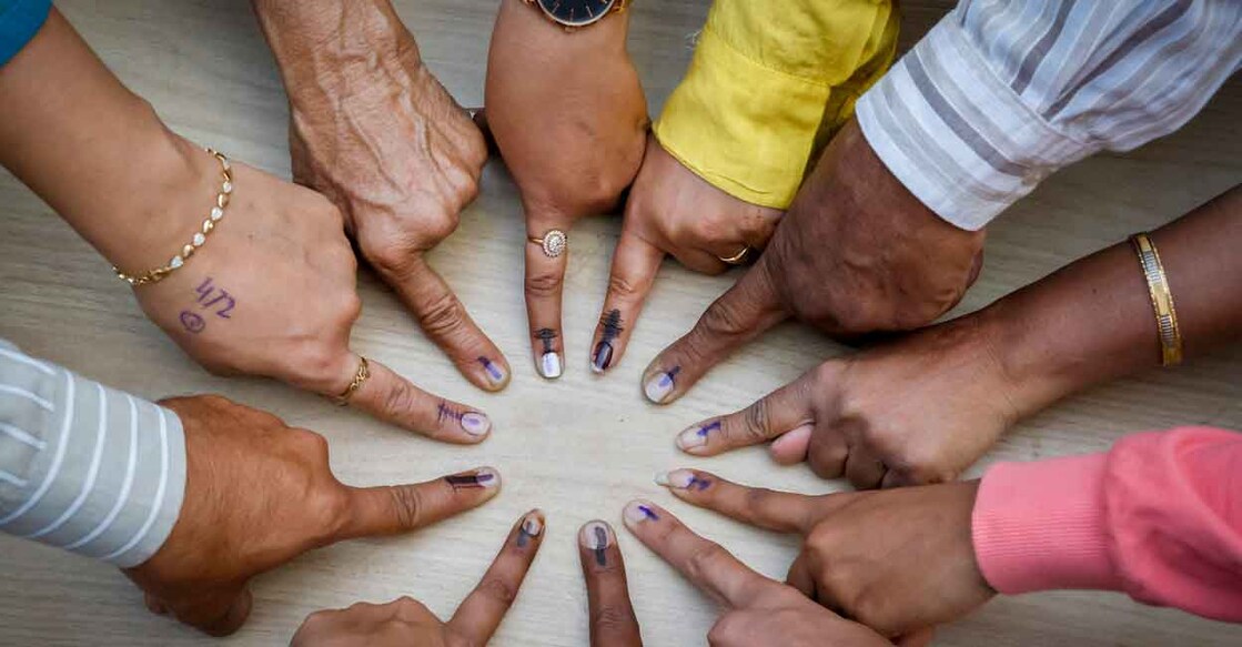  Voters pose for a photo showing their fingers marked with indelible ink after casting their votes during the second and final phase of Gujarat Assembly elections, at a polling station in Ahmedabad, Monday, Dec. 5, 2022. File photo: PTI