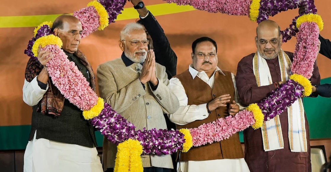 Prime Minister Narendra Modi, Defence Minister Rajnath Singh, Union Home Minister Amit Shah and BJP National President J.P. Nadda being garlanded during the celebrations of BJP's victory in the Gujarat Assembly elections, at party headquarters in New Delhi, Thursday, Dec. 8, 2022. Photo: PTI/Atul Yadav
