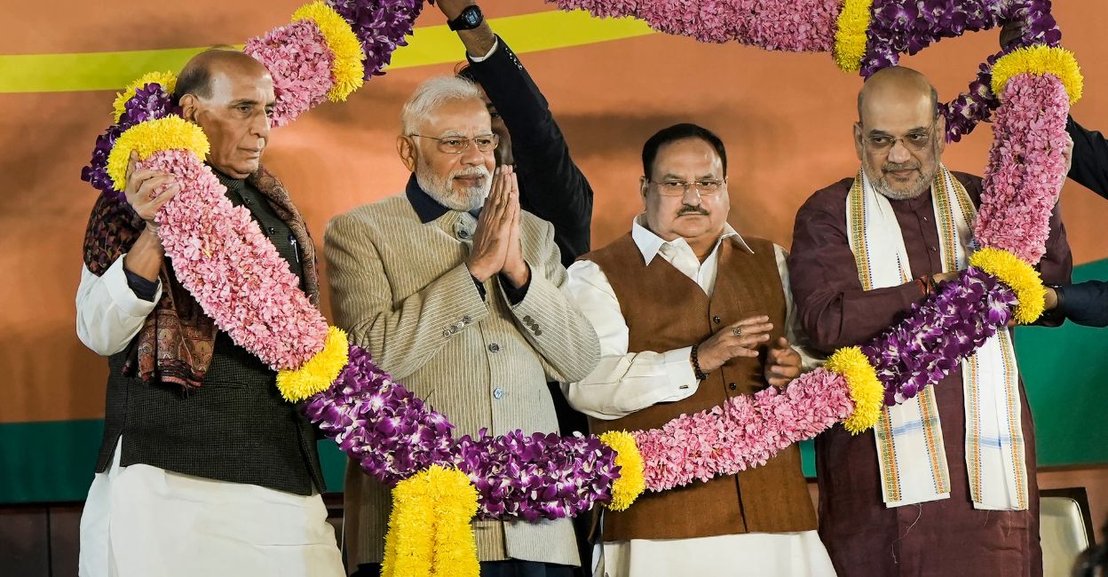 Prime Minister Narendra Modi, Defence Minister Rajnath Singh, Union Home Minister Amit Shah and BJP National President J.P. Nadda being garlanded during the celebrations of BJP's victory in the Gujarat Assembly elections, at party headquarters in New Delhi, Thursday, Dec. 8, 2022. Photo: PTI/Atul Yadav