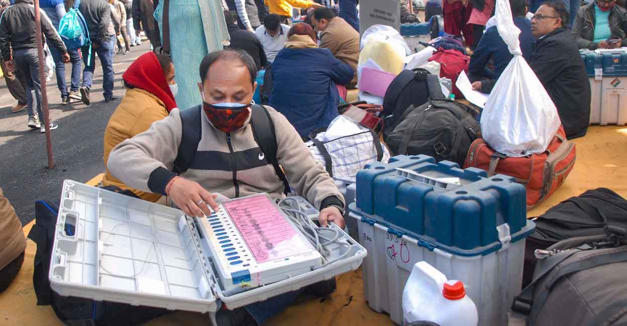 Polling officials check election material after collecting from a distribution centre, a day before the Uttar Pradesh Assembly elections, in Noida, Wednesday, Feb. 9, 2022.  Photo: PTI