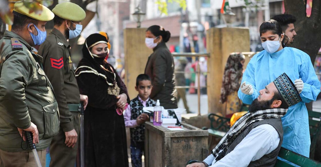 A healthcare worker conducts COVID-19 testing in Jammu, Sunday, Feb. 13, 2022. Photo: PTI
