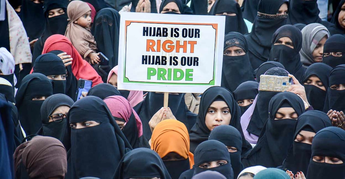 A woman holds a placard during a protest in support of female Muslim students of Karnataka over 'hijab' issue, in Thane, Sunday, February 13, 2022. Photo: PTI