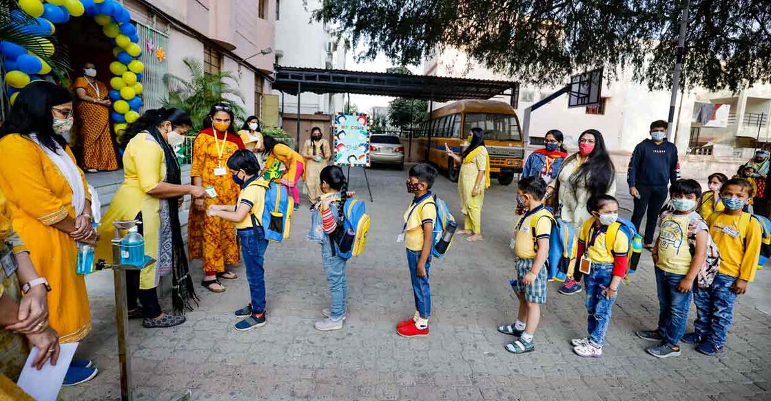 Students undergo thermal testing before entering the school as authorities allowed to reopen the junior and senior kindergarten schools, following ease in Covid-induced restrictions, in Ahmedabad, Thursday, Feb. 17, 2022.  Photo: PTI