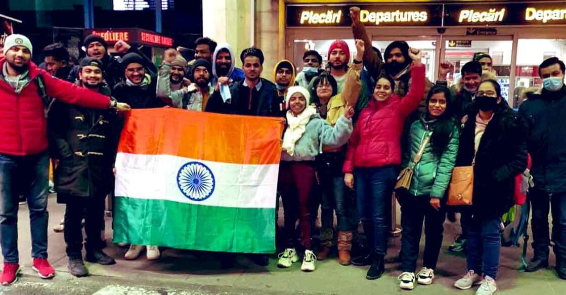 A group of Indian students pose with the national flag before their evacuation flight from Bucharest early on Sunday. Photo: Twitter/ @DrSJaishankar