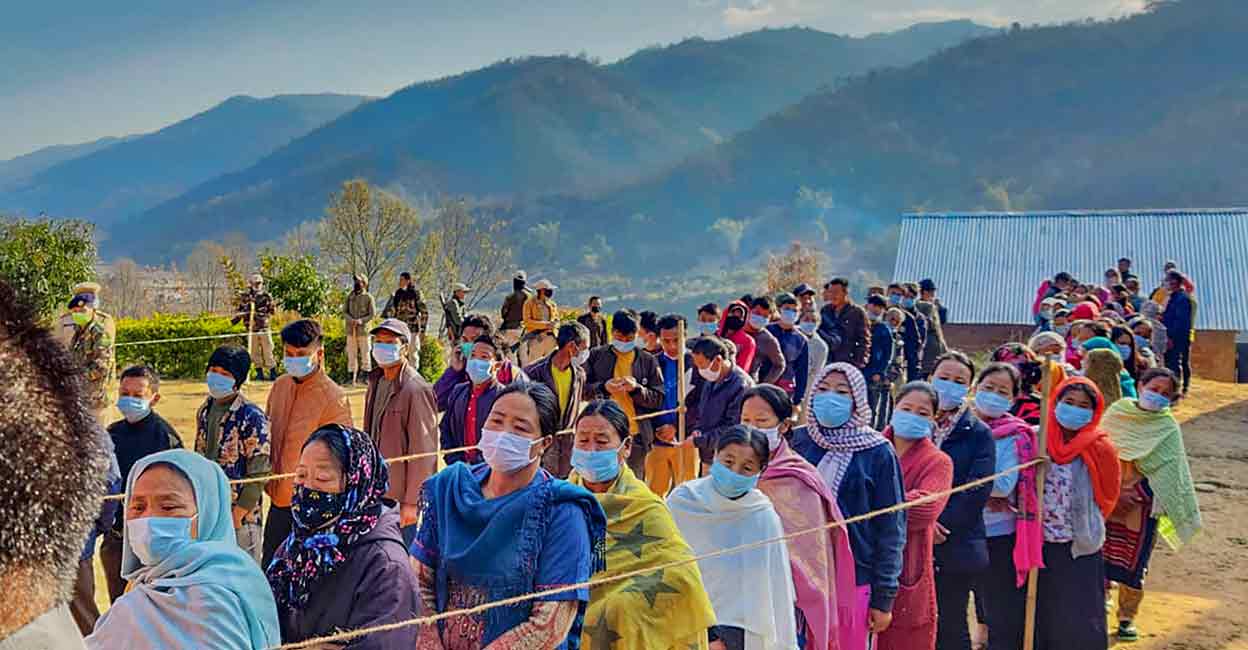 PTI03_08_2022_000016B People wait to cast their votes for Assemply elections, during repolling in Senapati, Manipur, Tuesday, March 8, 2022. PTI