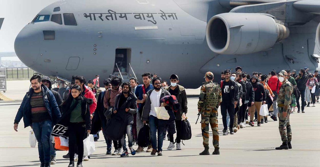 Indian nationals, evacuated from war-hit Ukraine, walk after deboarding from an IAF plane, upon its arrival at Hindan airbase, in Ghaziabad, Friday, March 11, 2022. Photo: Manvender Vashist/PTI