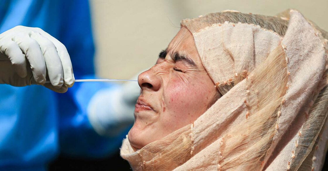 A healthworker conducts COVID-19 testing at a market in Jammu, Saturday, March 12, 2022. Photo: PTI