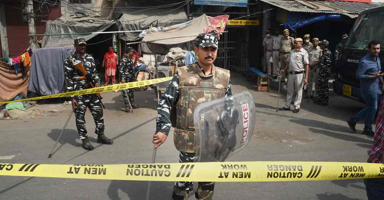 Security personnel keep vigil after clashes broke out between two communities during a Hanuman Jayanti procession on Saturday, at Jahangirpuri in New Delhi, Monday, April 18, 2022. (PTI Photo/Shahbaz Khan)