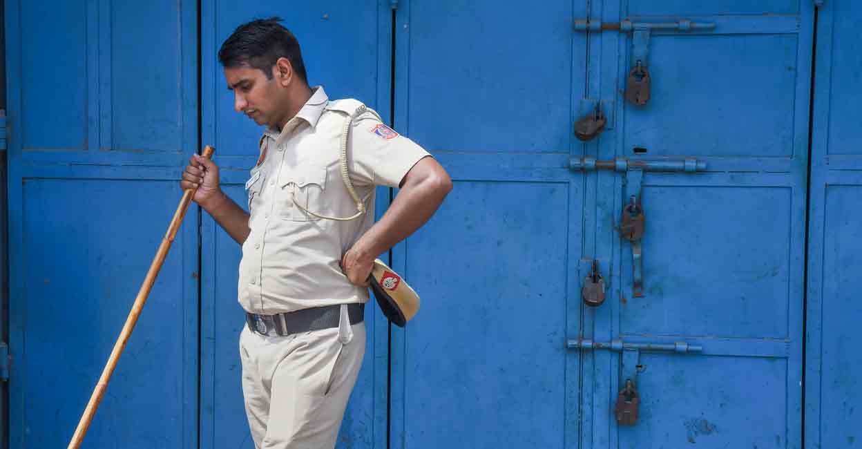 A policeman stands guard in the violence-hit Jahangirpuri area in New Delhi on Tuesday. Photo: PTI