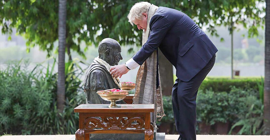 UK Prime Minister Boris Johnson garlands a statue of Mahatma Gandhi during his visit to the Sabarmati Ashram, in Ahmedabad. Photo: PTI