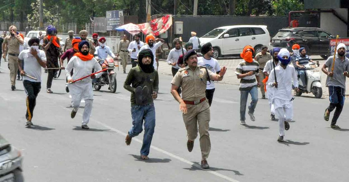 Security personnel attempt to maintain law and order after a clash broke out between followers of Shiv Sena and pro-Khalistani Sikh organisations near Kali Mata Mandir in Patiala on Friday. Photo: PTI