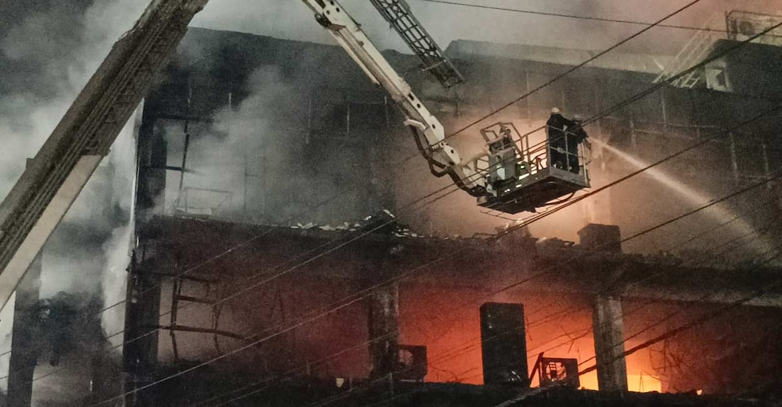 Firefighters try to douse a fire which broke out in a building at Mundka, in West Delhi. Photo: PTI