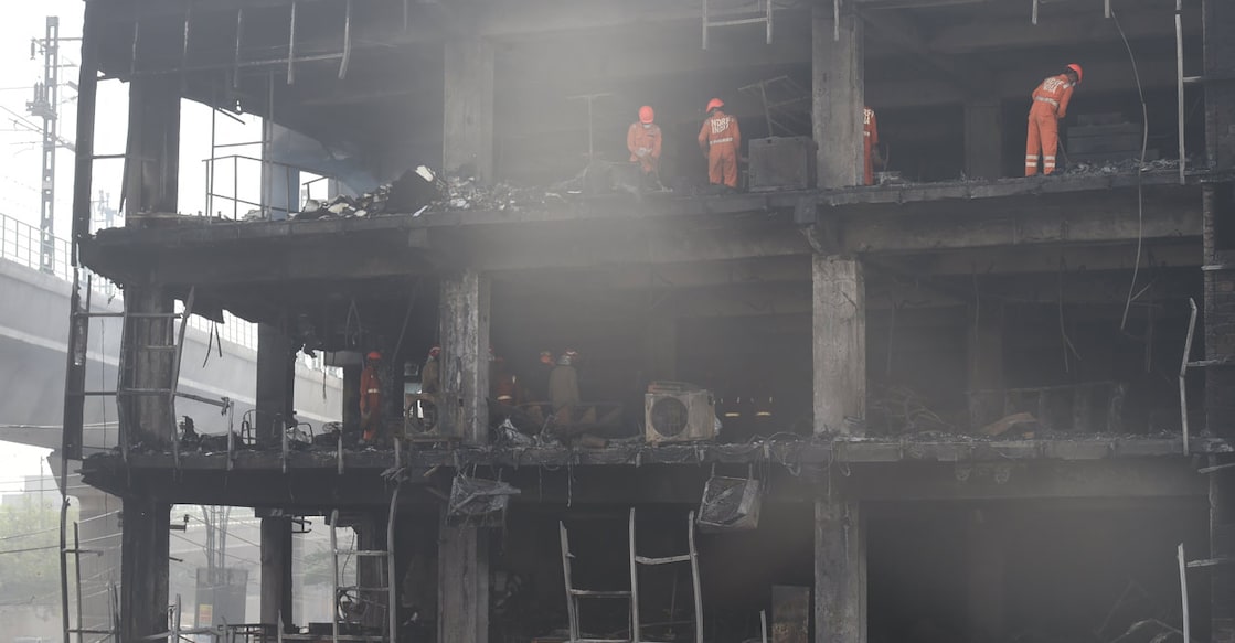 NDRF personnel during rescue and relief work after a massive fire at an office building near the Mundka Metro Station, in West Delhi. Photo: PTI