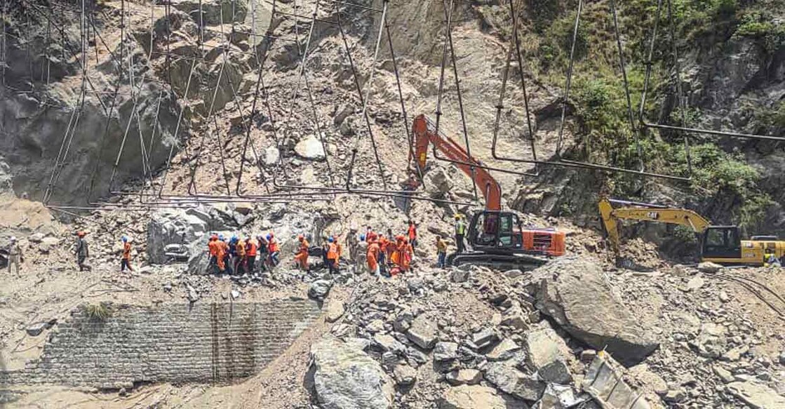 PTI05_21_2022_000097B Rescue operation underway on the second consecutive day to save labourers trapped under debris following the collapse of an under-construction tunnel on the Jammu-Srinagar national highway near Magarkote in Ramban district on Saturday. Photo: PTI
