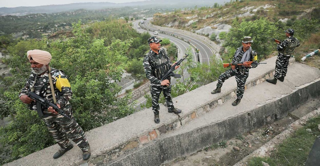 CRPF personnel stand guard at the Jammu-Srinagar National Highway as security convoy leaves for Kashmir in preparation for the 'Amarnath Yatra', in Jammu, Monday, May 30, 2022. Photo: PTI