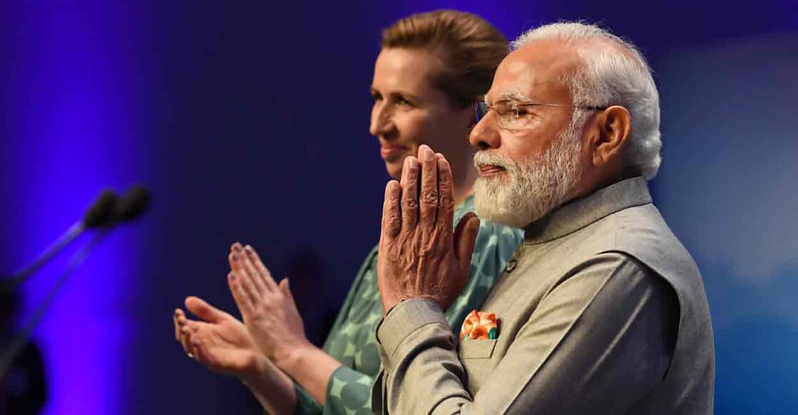 Prime Minister Narendra Modi greets the members of the Indian community, during an event, in Copenhagen, Denmark. Prime Minister of Denmark Mette Frederiksen is also seen. Photo: PTI