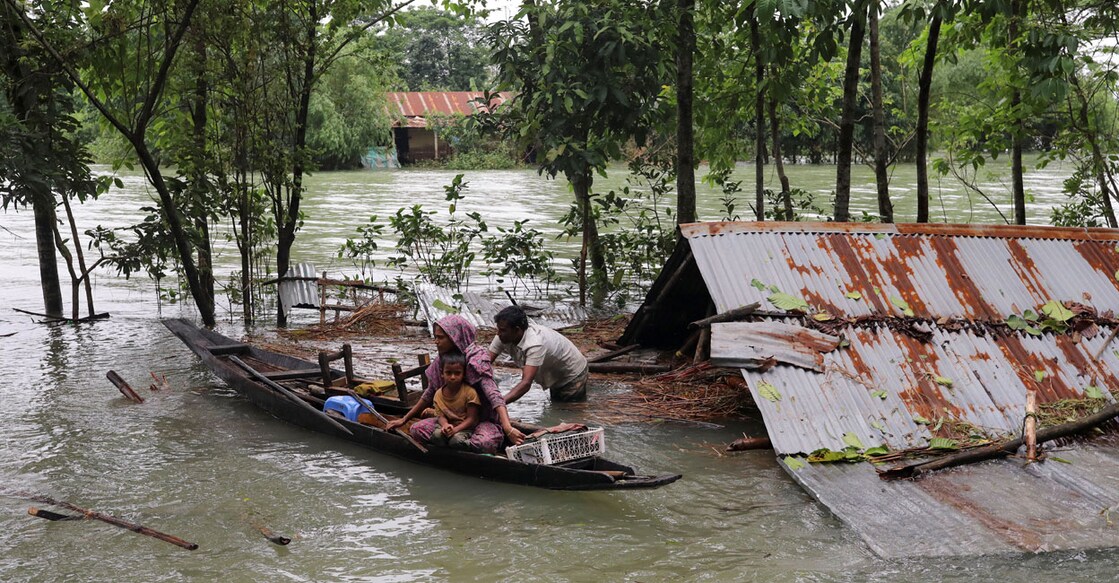People get on a boat as they look for shelter during a widespread flood in the northeastern part of the country, in Sylhet, Bangladesh on Sunday. Photo: Reuters/ Kazi Salahuddin Razu
