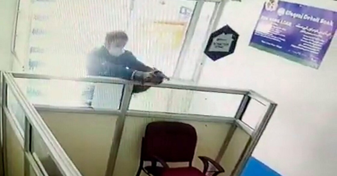 A militant shoots at bank manager Vijay Kumar (unseen), after entering the Areh branch of Elaqahi Dehati Bank in Kulgam district on Thursday. Photo: Screengrab released by PTI