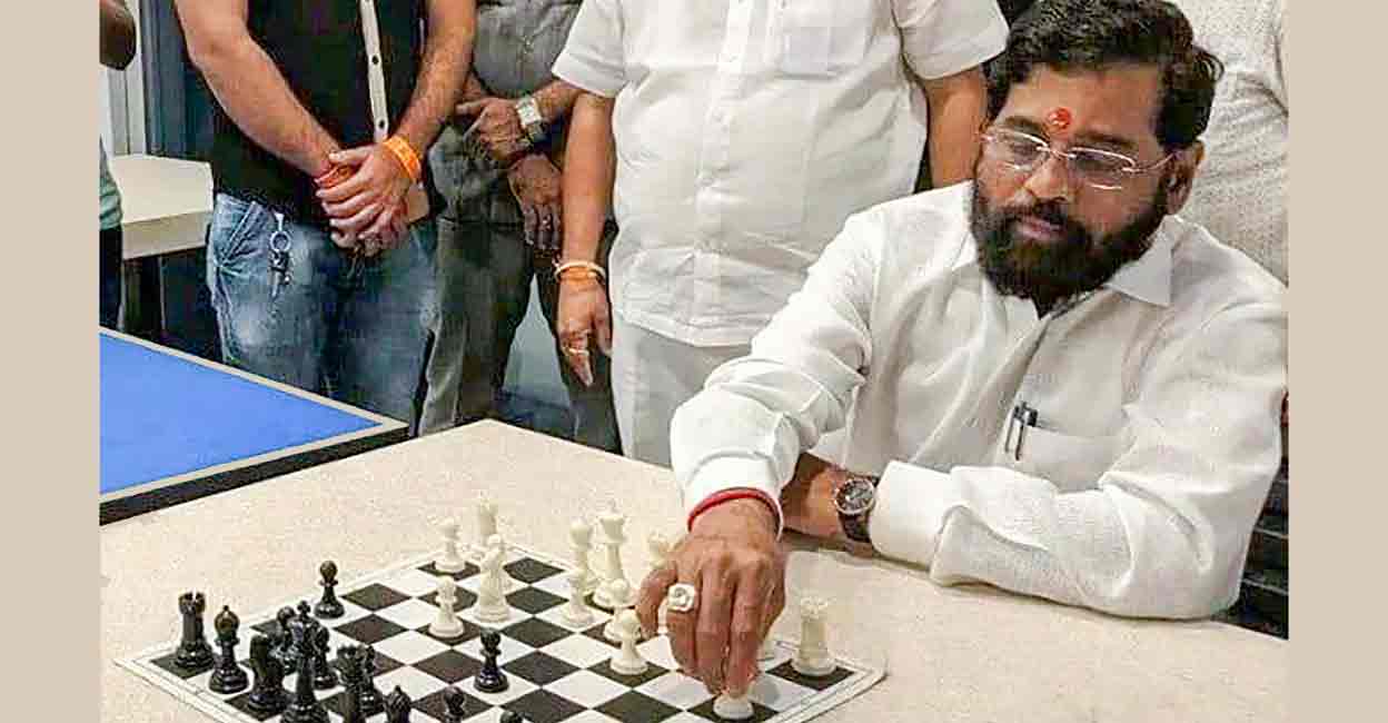 Rebel Shiv Sena leader Eknath Shinde plays chess at a hotel where he is staying with supporting MLAs, in Guwahati, Thursday, June 23, 2022. (PTI Photo)