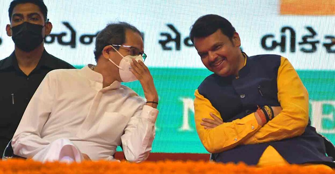 Maharashtra Chief Minister Uddhav Thackeray and Leader of Opposition Devendra Fadnavis interacting with each other at the 'Dwishatabdi Mahotsav' of Mumbai Samachar, in Mumbai on Tuesday, 14 June 2022. (Photo: Nitin Lawate/IANS)
