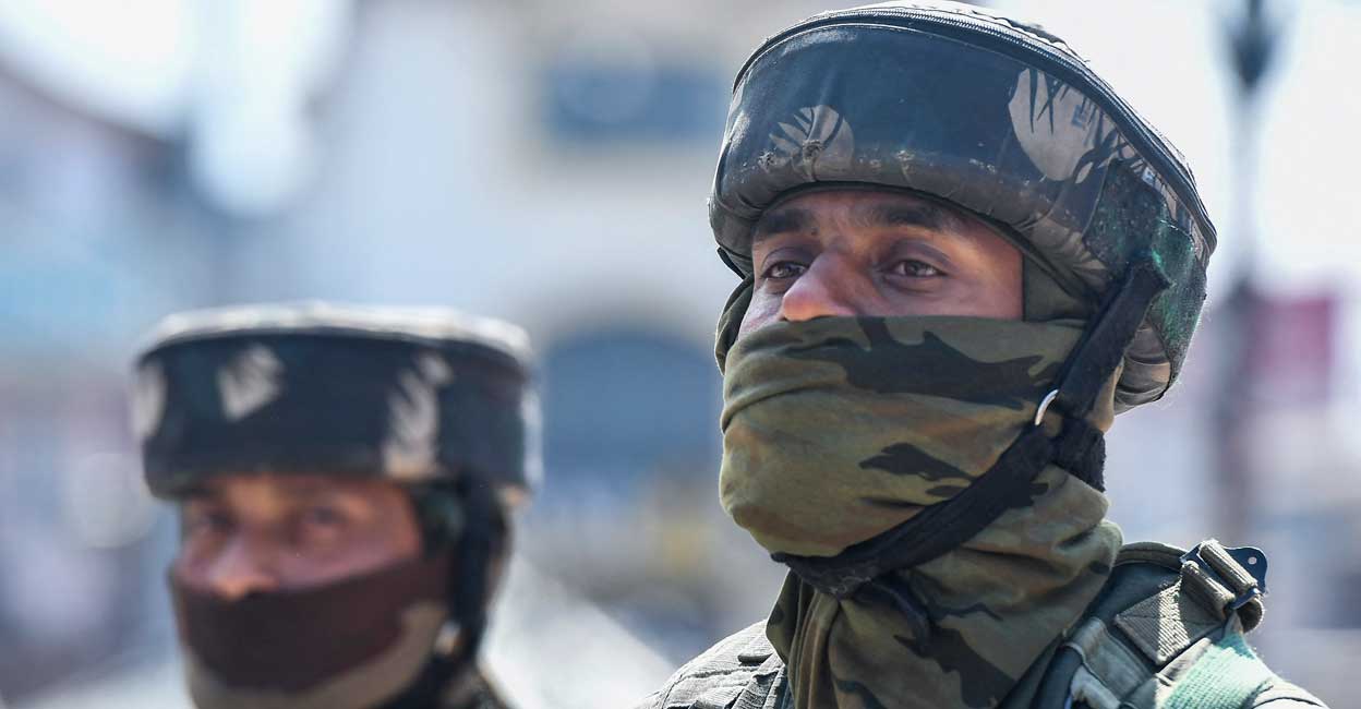 Paramilitary troopers stand guard along a street during a random search in Srinagar on June 2, 2022. Photo: Tauseef Mustafa /AFP