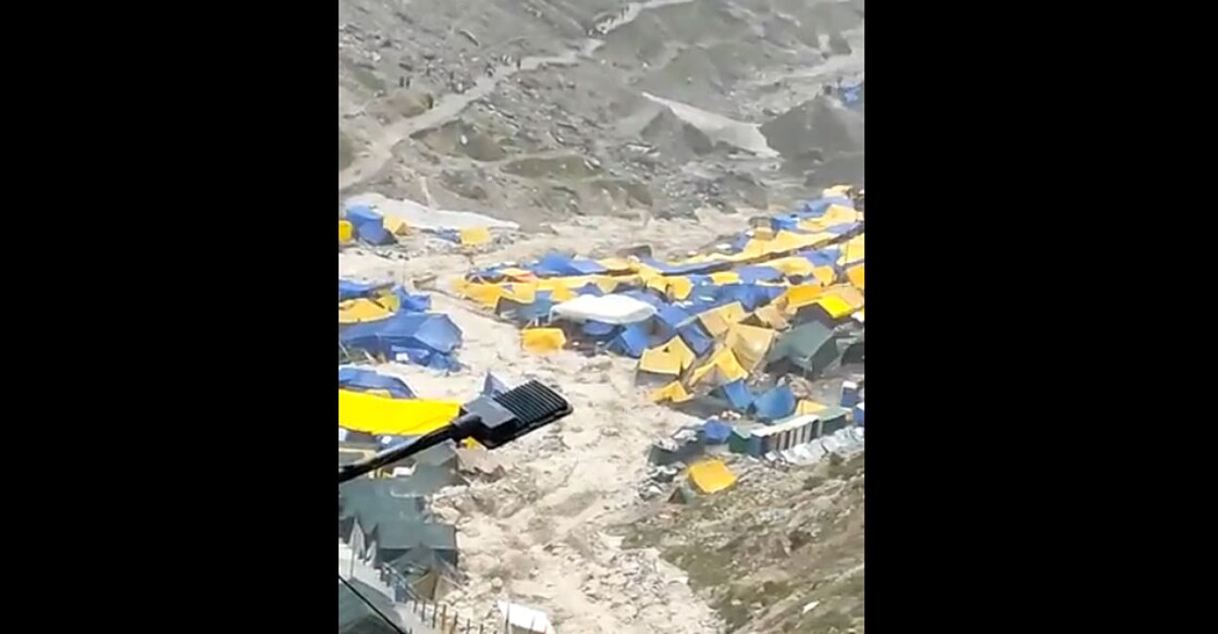 A screengrab of floodwater gushing toward tents. 