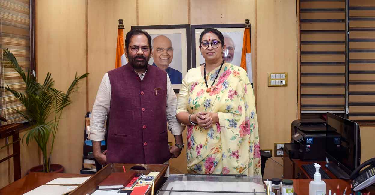 Union Women and Child Development Minister Smriti Irani with former union minister Mukhtar Abbas Naqvi during taking additional charge of the Ministry of Minority Affairs, in New Delhi, Thursday, July 7, 2022. (PTI Photo/Kamal Singh)