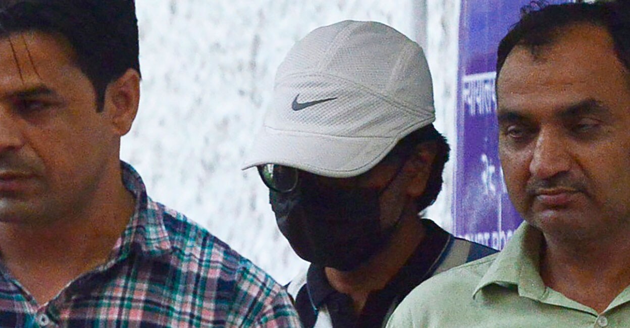 Mohammed Zubair Alt News co-founder Mohammed Zubair (in white cap) is escorted by policemen at the Patiala House Court in New Delhi on July 2. Photo: AFP