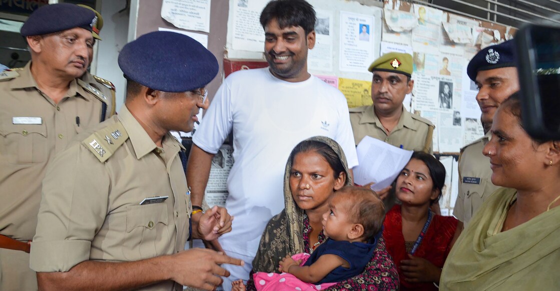 Police hands over the 7-month-old boy to his mother after he was recovered from Firozabad in a corporator's house, in Mathura, Monday, Aug. 29, 2022. The boy was lifted from the Mathura Station while he was sleeping next to his parents.  Photo: PTI