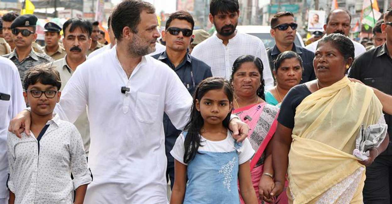 Rahul Gandhi walking with two children during the Bharat Jodo Yatra. Photo: Twitter/@RahulGandhi