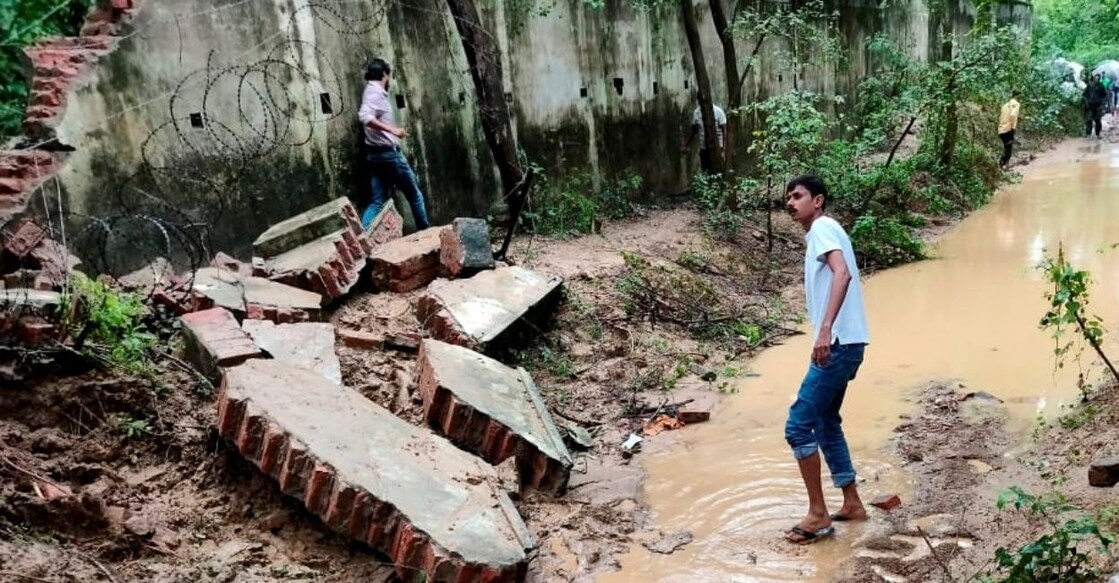 Debris lies on the ground after the boundary wall of an Army enclave collapsed due to heavy overnight rains, in Lucknow, Friday, September 16, 2022. Photo: PTI