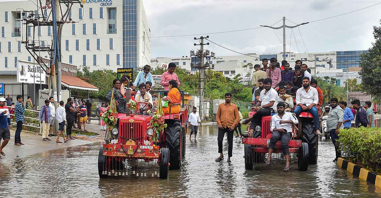 Bengaluru: Tractors being used to evacuate people stranded at the waterlogged Yemalur area after heavy monsoon rains, in Bengaluru, Tuesday, Sept. 6, 2022. (PTI Photo/Shailendra Bhojak)