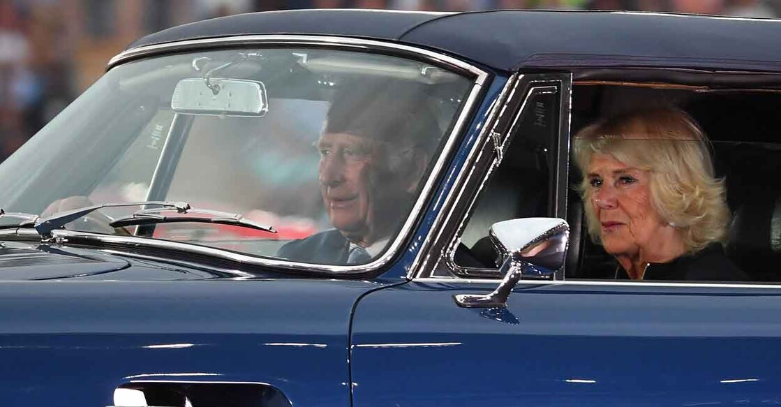 Prince Charles, Prince of Wales (L) drives with Britain's Camilla, Duchess of Cornwall in an Aston Martin sports car into the opening ceremony for the Commonwealth Games, at the Alexander Stadium in Birmingham, central England, on July 28, 2022. Photo: ANDY BUCHANAN/AFP