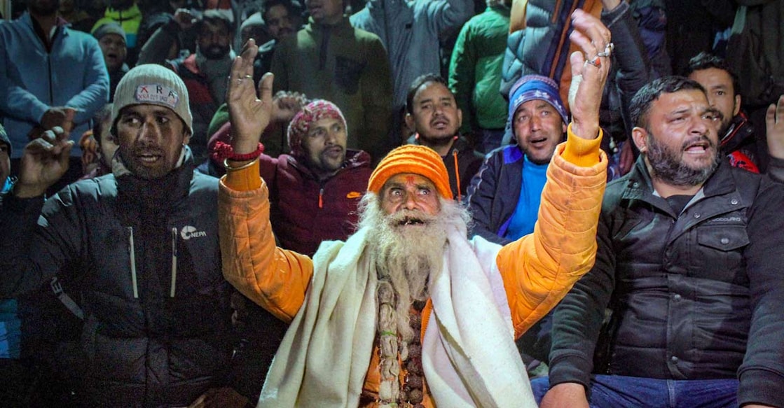 PTI01_10_2023_000326A Joshimath: A sadhu with locals protests against the demolision of the unsafe hotels and houses after cracks appeared at the landslide affected area of Joshimath, in Chamoli district: PTI Photo