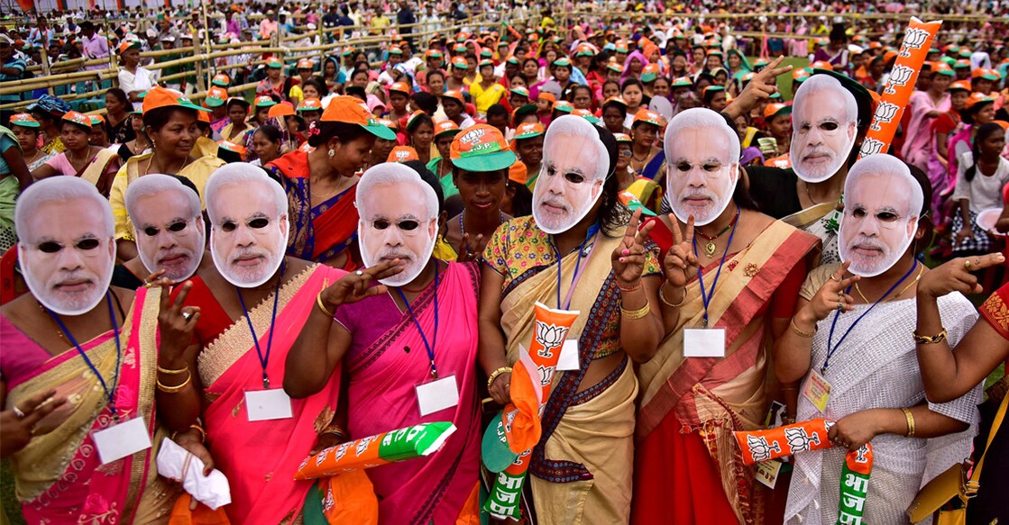 Supporter of India's ruling Bharatiya Janata Party (BJP) wearing masks of Prime Minister Narendra Modi attend an election campaign rally addressed by Modi at Moran town in the northeastern state of Assam. Photo: Reuters/ Anuwar Hazarika