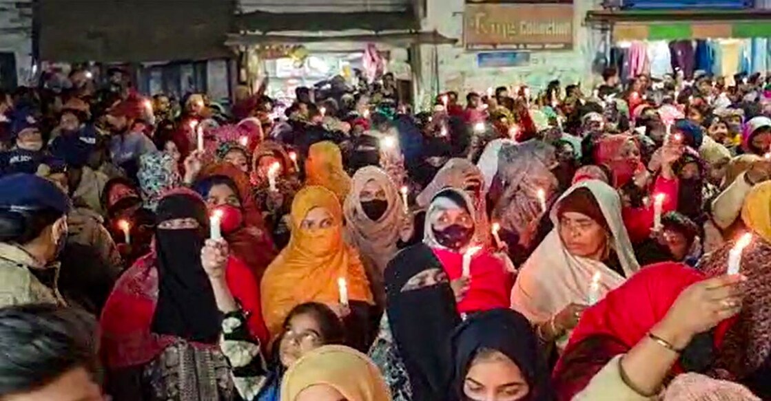 Residents take out a candle march against the Uttarakhand High Court's order for removal of encroachments from the railway land, in Haldwani: PTI Photo