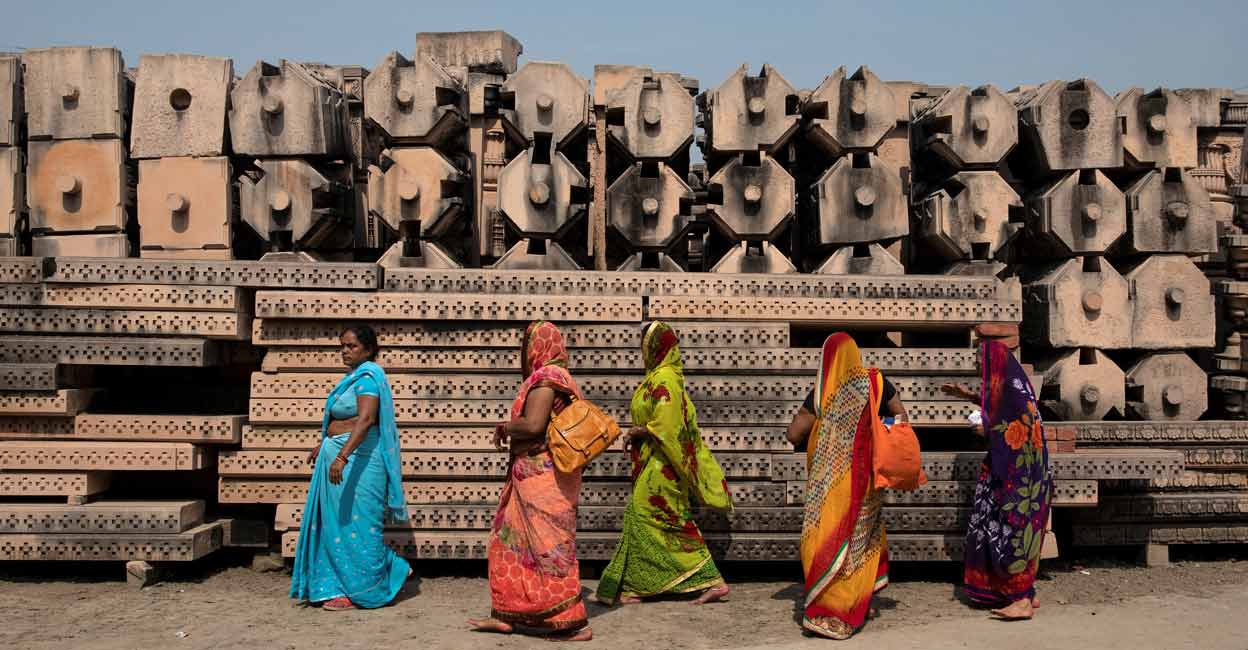 INDIA-RELIGION-TEMPLE Devotees walk past the pillars that Hindu nationalist group Vishva Hindu Parishad (VHP) say will be used to build a Ram temple at the disputed religious site in Ayodhya, India, October 22, 2019. File photo: Reuters/Danish Siddiqui