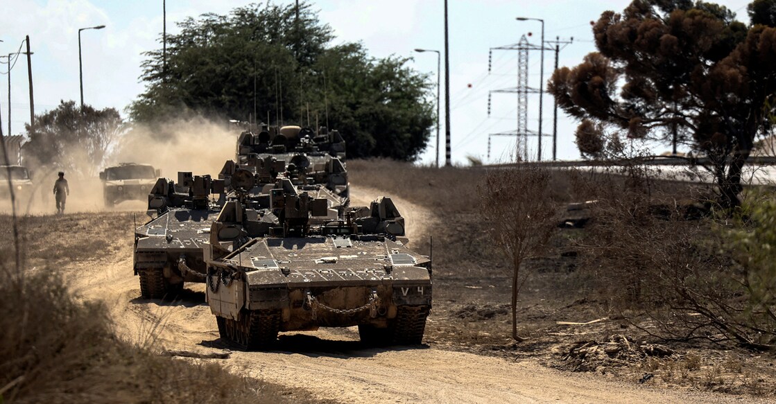 Israeli military vehicles drive near Israel's border with the Gaza Strip, in southern Israel. Photo: Reuters