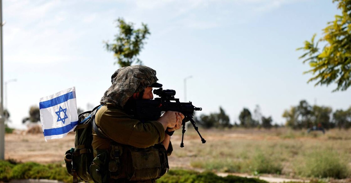 israel-soldier-c An Israeli soldier secures an area, following a deadly infiltration by Hamas gunmen from the Gaza Strip, in Kibbutz Kissufim in southern Israel . Photo: Reuters