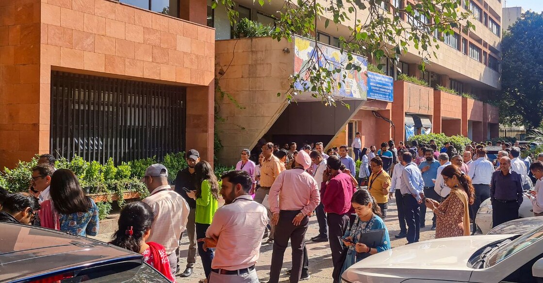 People gather outside their offices after tremors were felt due to an earthquake, in New Delhi, Tuesday, October 3, 2023. Photo: PTI