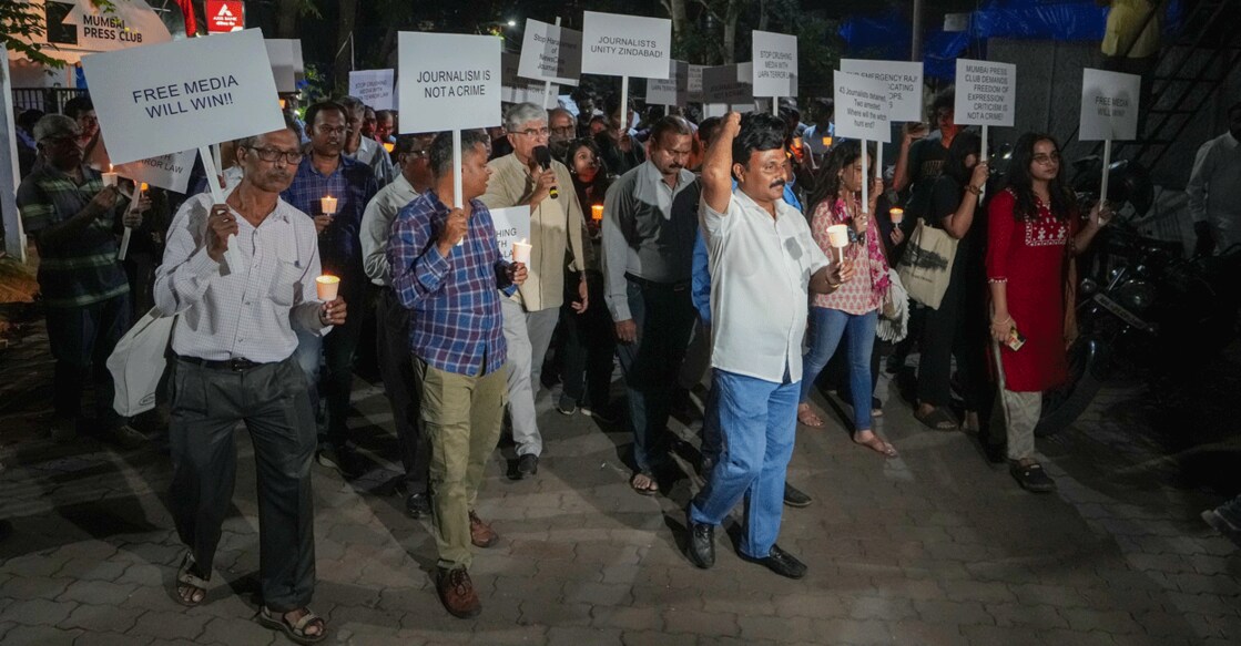 Journalists take part in a candle march against Police raid on news portal NewsClick, in Mumbai on Thursday. Photo: PTI