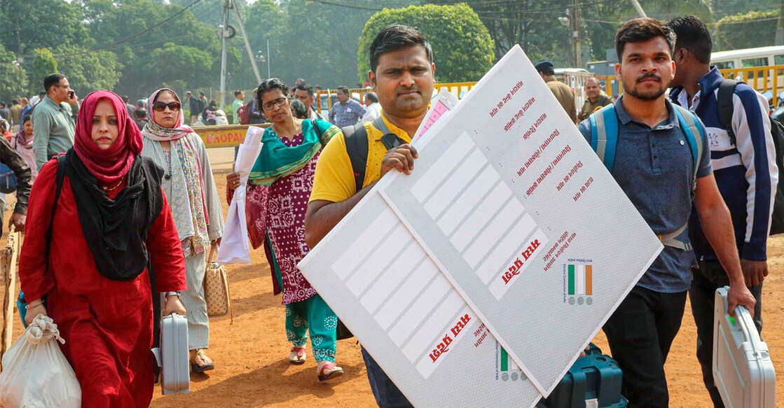 Polling officials with EVMs and other election material leave for poll duty ahead of Madhya Pradesh Assembly elections, in Bhopal, on Thursday. Photo: PTI