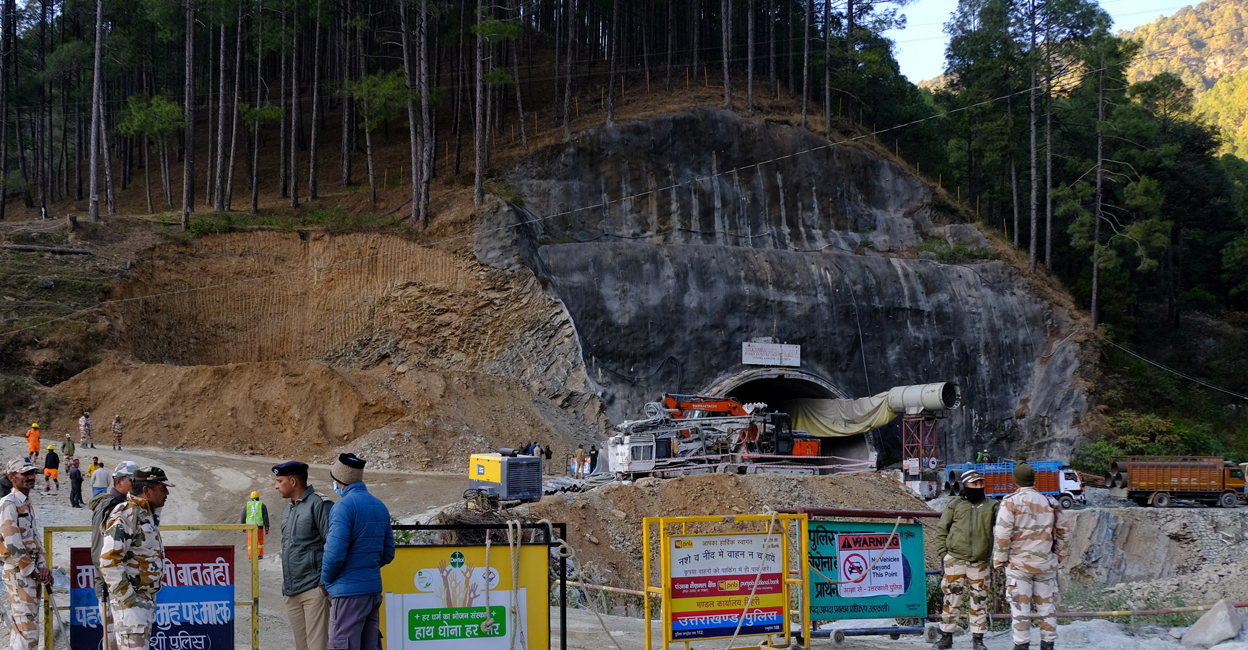 uttarakhand-tunnel-collapse Police officers stand guard next to a barricade past the entrance of a tunnel where 40 road workers are trapped after a portion of the tunnel collapsed in Uttarkashi. Photo: Reuters