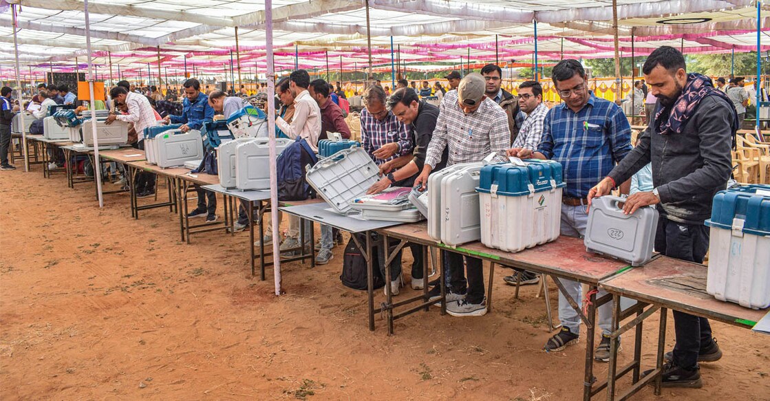 Polling officials collect EVMs and other election material at a distribution centre ahead of voting for Rajasthan Assembly elections, in Ajmer on Friday. Photo: PTI/ Shaukat Ahmed