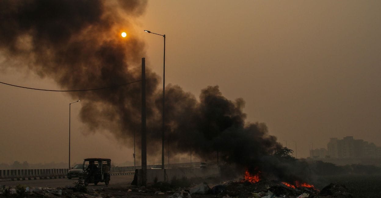 Untitled design - 1 Smoke rising from burning garbage adds to the air pollution, in Gurugram on Thursday. Photo: PTI