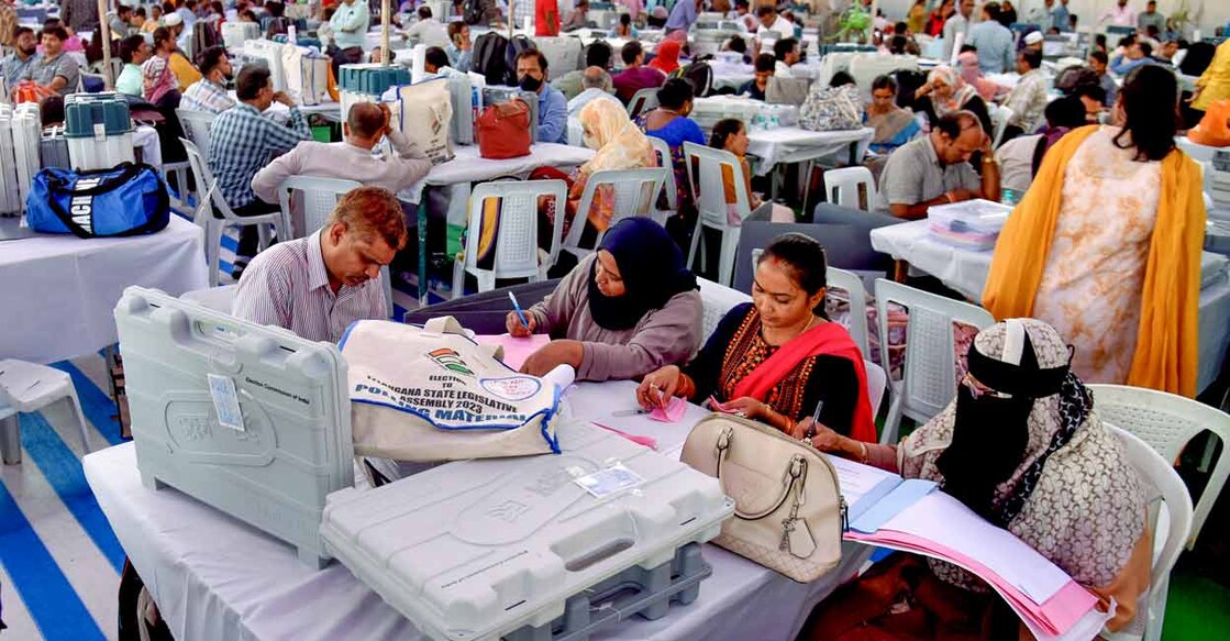 PTI11_29_2023_000239B Polling officials collect EVMs and other polling materials on the eve of the Telangana Assembly election, at a distribution centre in Hyderabad, Wednesday, Nov. 29, 2023. Phoo: PTI
