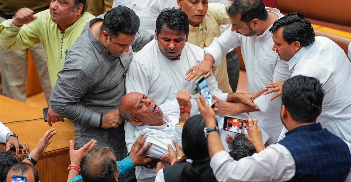 A councillor collapses amid clashes between councillors of AAP and BJP during the election of members of the MCD Standing Committee, at the Civic Centre in New Delhi on Friday. Photo: PTI