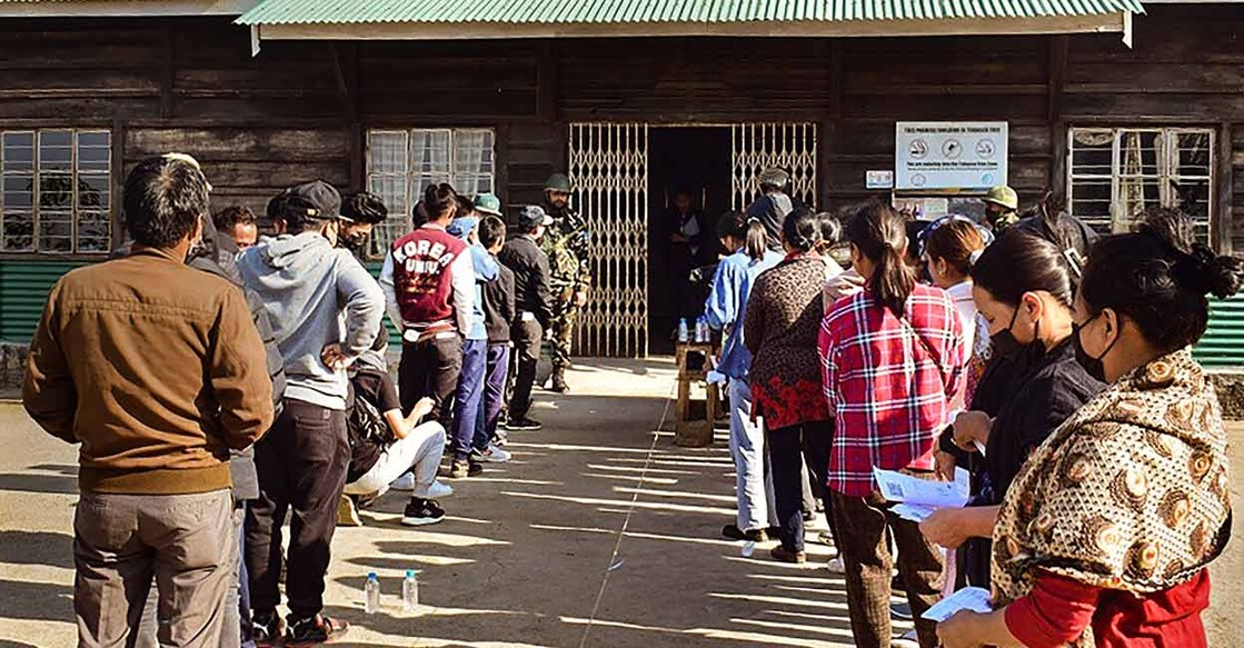Voters wait in queues to cast their votes at a polling booth during the Nagaland Assembly elections on Monday. Photo: PTI