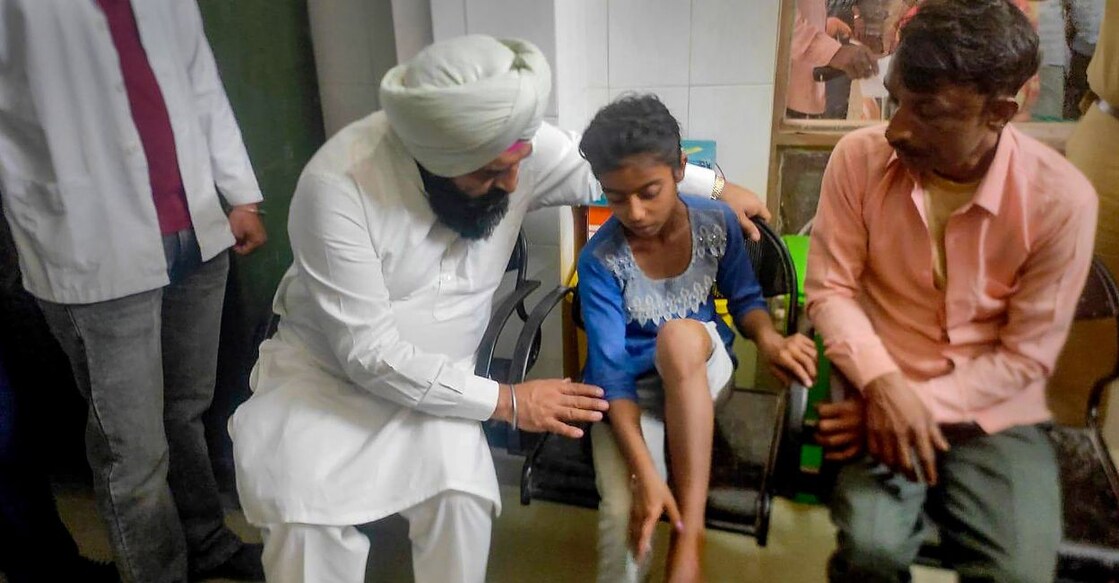 Deputy speaker of Punjab Assembly Jai Krishan Singh Rouri meets people injured in an accident with a truck, in Hoshiarpur district, Thursday, April 13, 2023. Photo: PTI