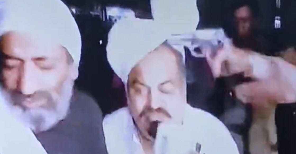 The screengrab from a television footage showing a gun aim at Atiq Ahmad's head. His brother Ashraf was also gunned down by 'unidentified' assailants.